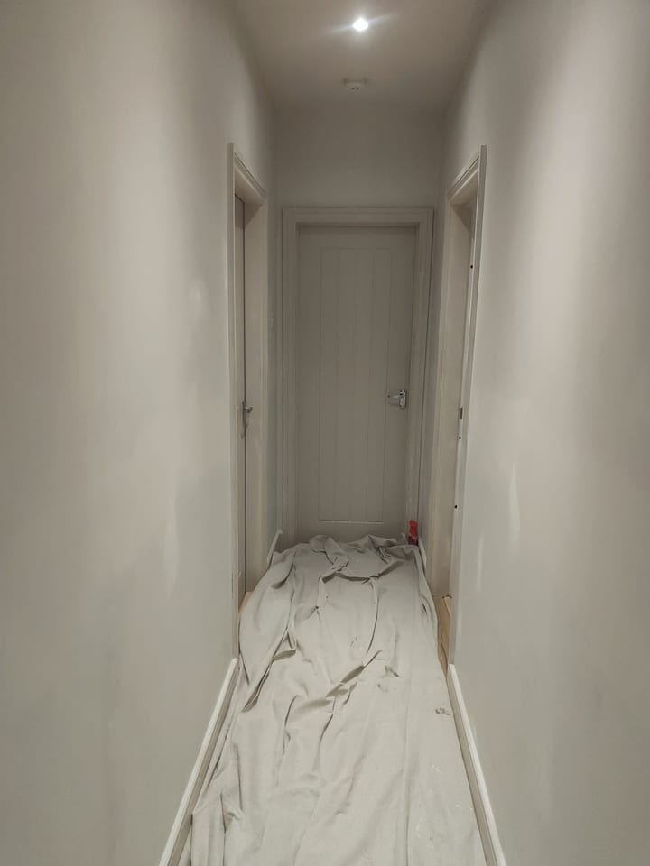 Hallway walls and ceiling prepared and painted in a soft neutral finish
