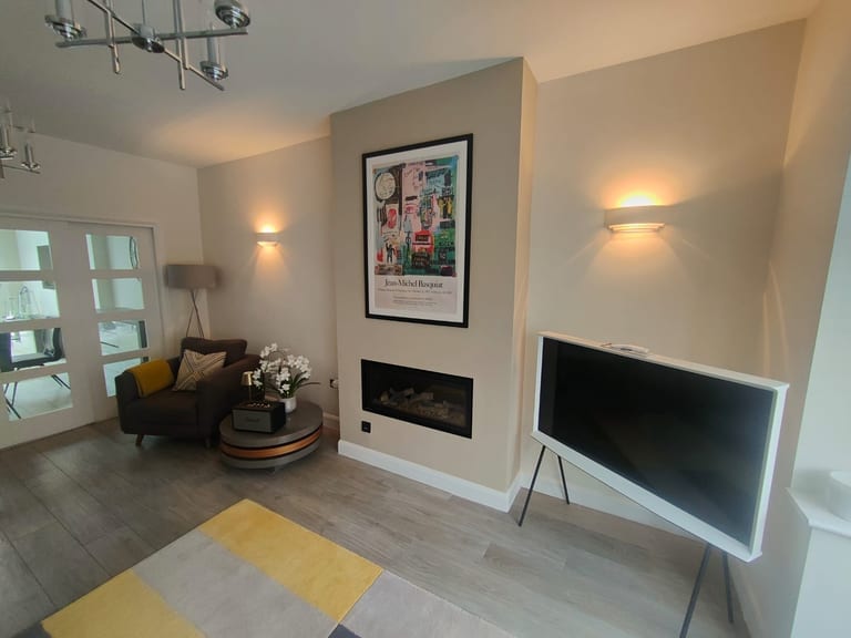 Finished living room with neutral painted walls and fireplace