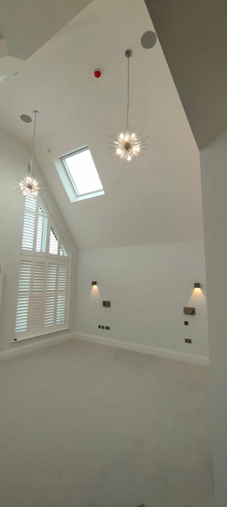 Freshly painted loft room with sloping ceiling