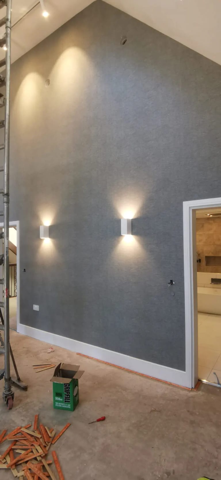 Grey feature wall with wall lights